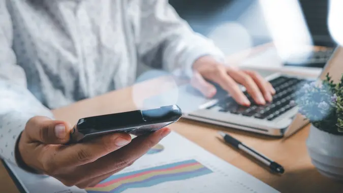 Business woman working with modern laptop computer and smart phone with financial business strateg stock photo