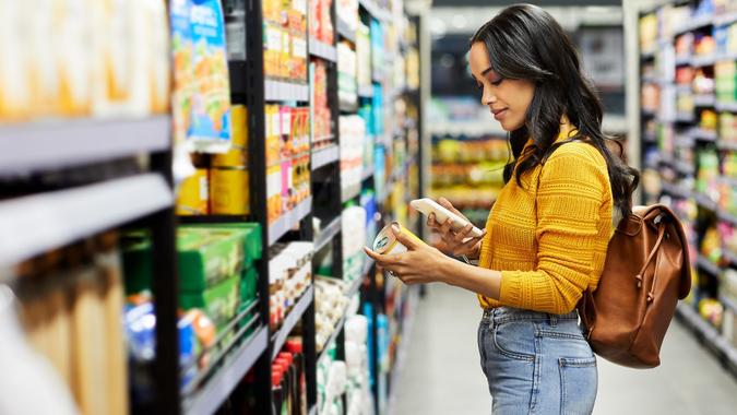 Shot of a young woman buying groceries in a supermarket stock photo
