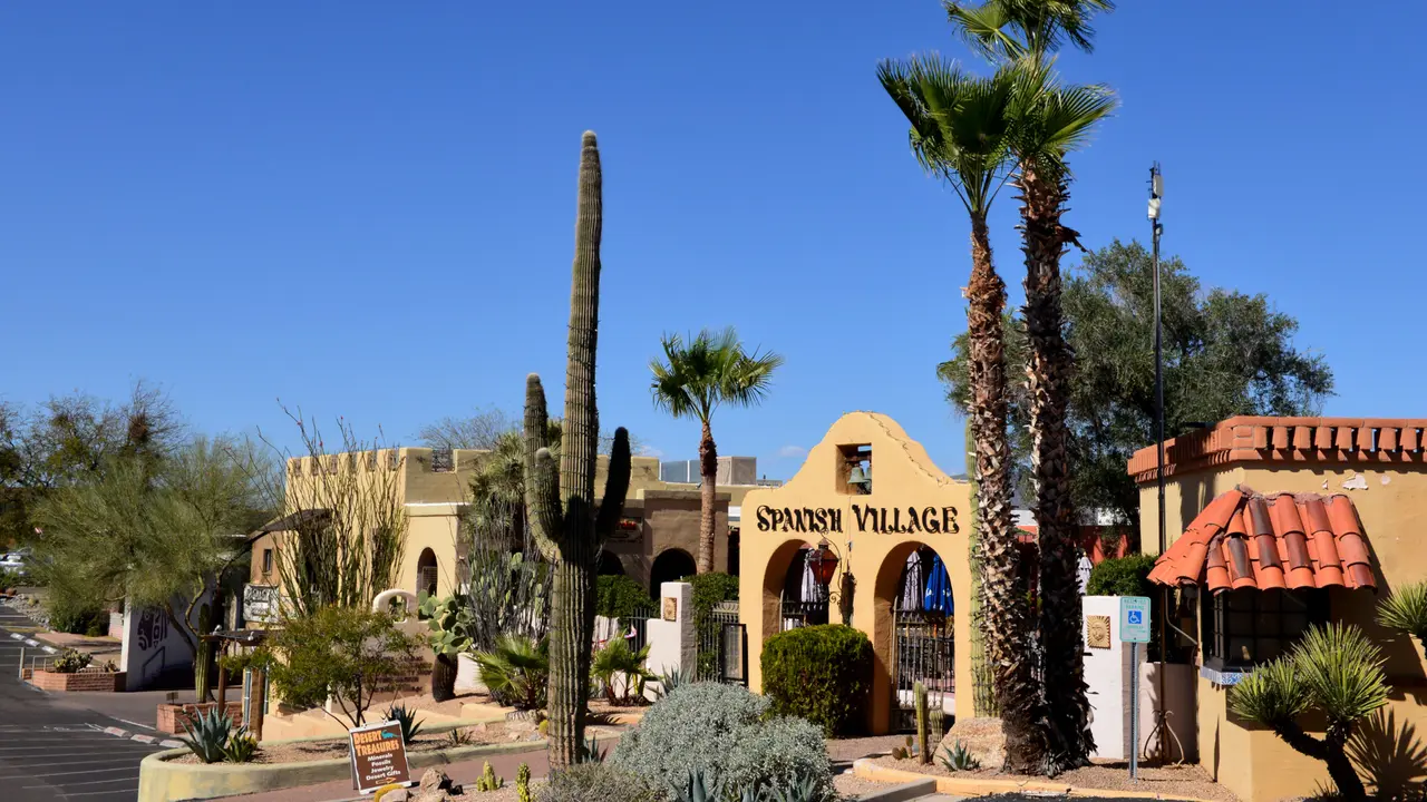 Carefree, AZ, USA - February 22, 2016: Entrance to the Spanish Village, a period looking shopping area in Carefree, Arizona, with local cactus and other vegetation.