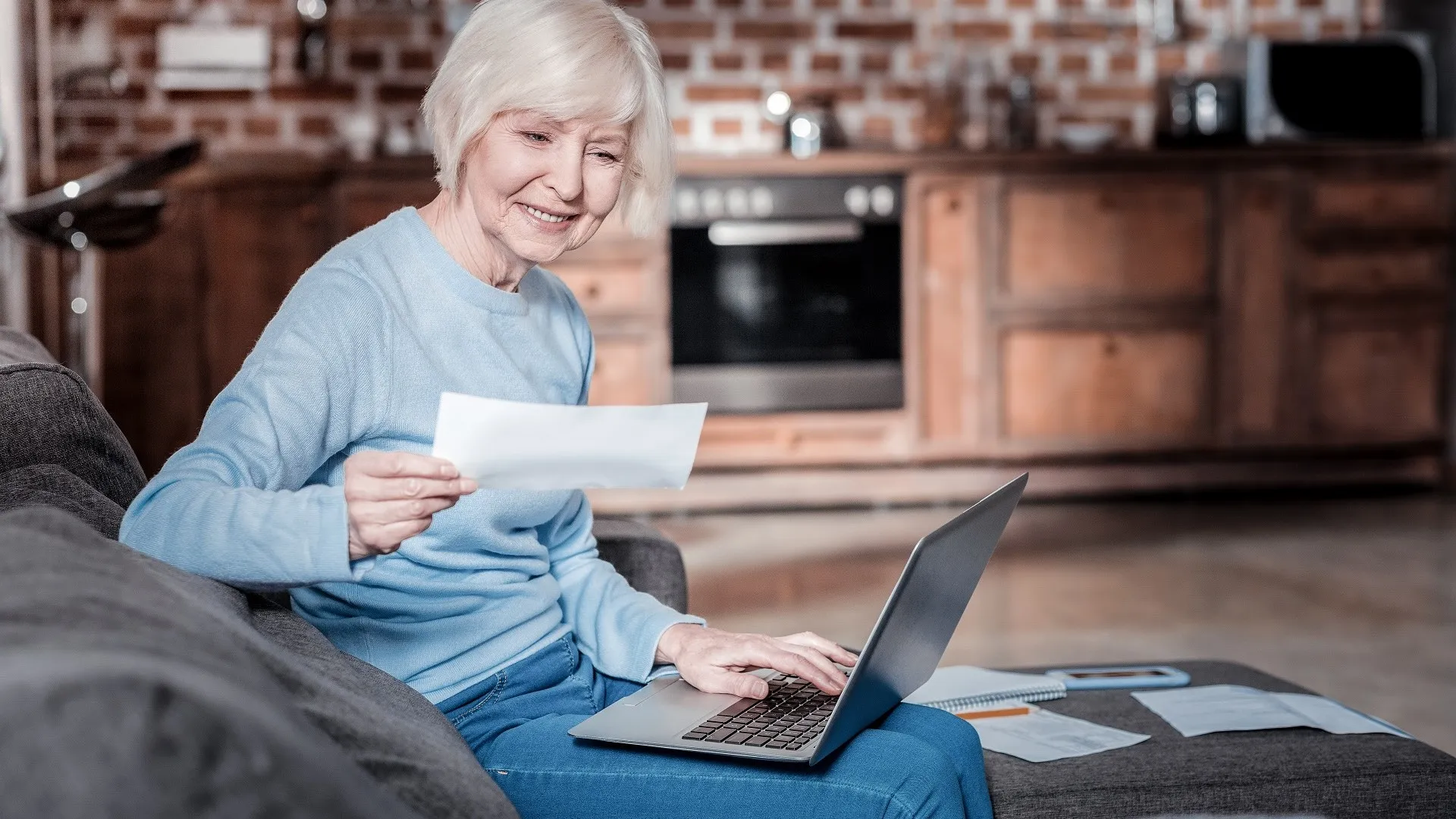 Relaxed mature woman working with computer stock photo