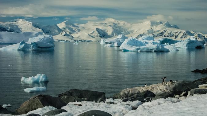 The landscape of the coast of Antarctica, Mountains covered with snow and ice-cold ocean.