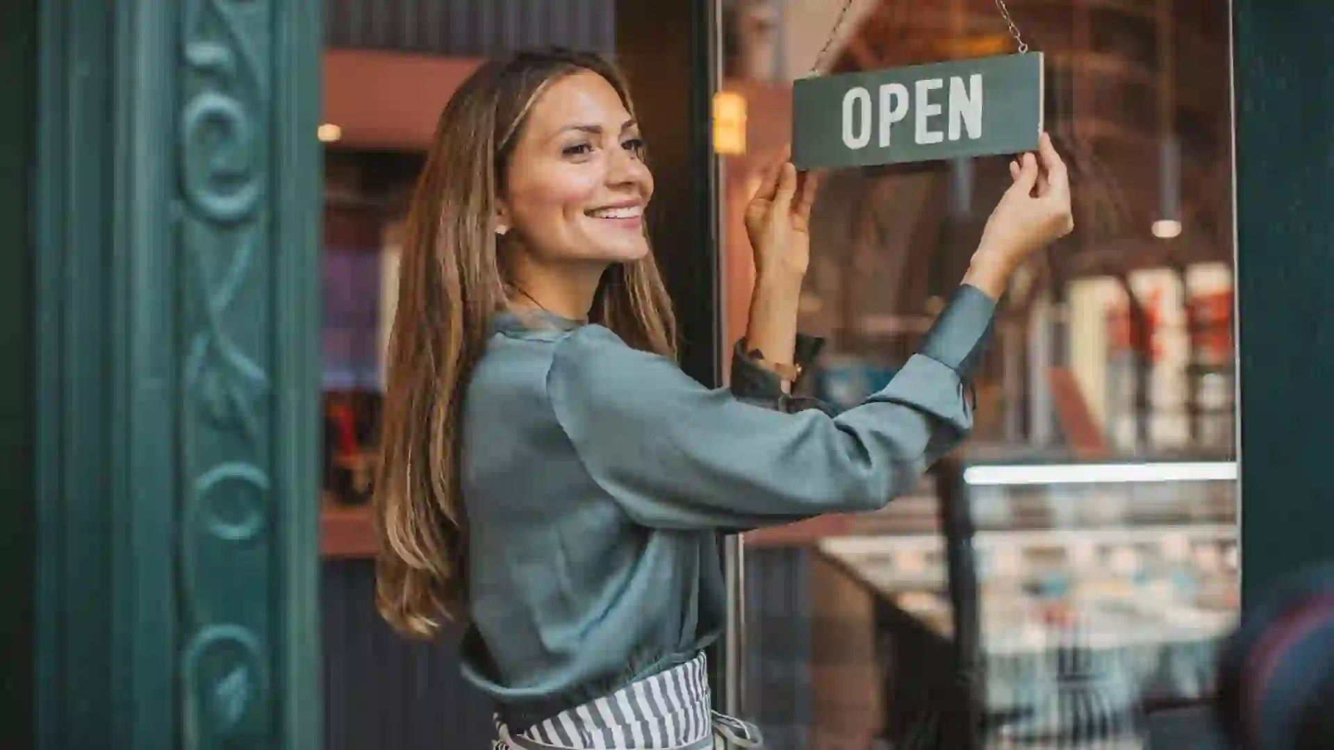 Young woman owner of ice cream shop in town.