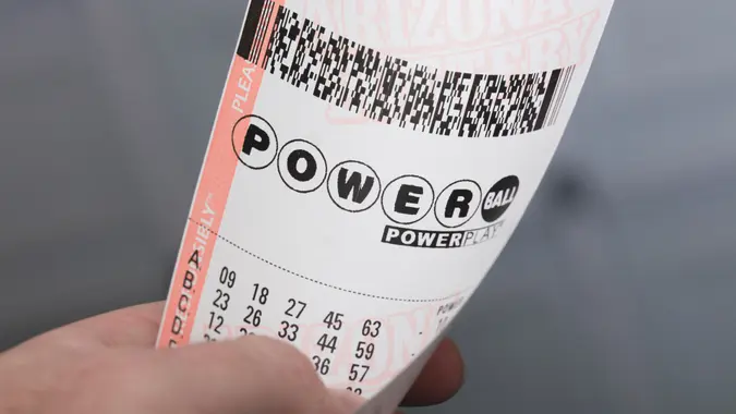 Kingman, USA - January 20, 2016: A photo of a man holding a Powerball lottery ticket in Kingman, Arizona.