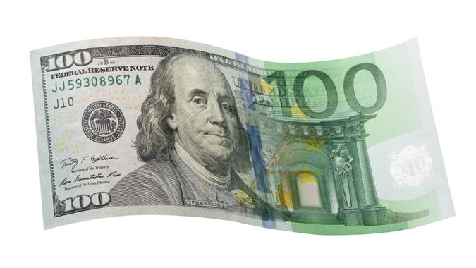Currency exchange of one hundred dollar banknote with one hundred euro banknote.
