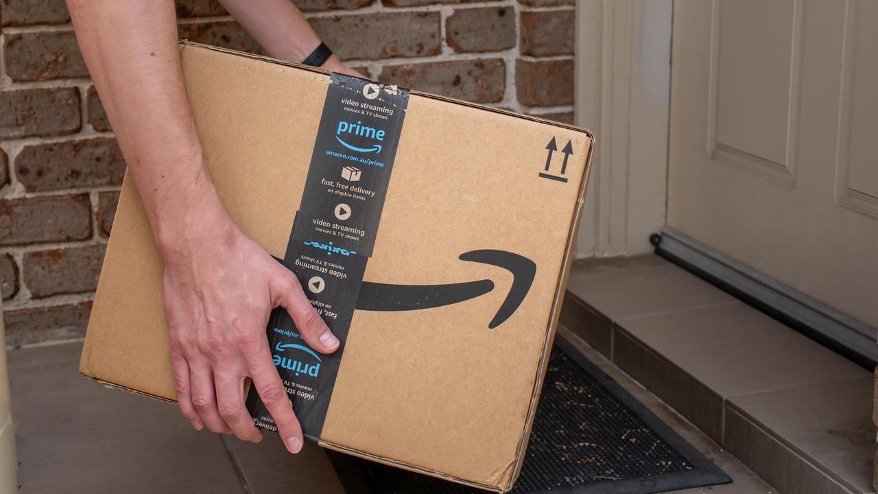 Amazon prime box delivered to a front door of residential building stock photo