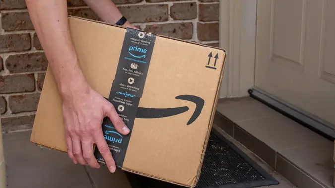 Amazon prime box delivered to the front door of a house stock photo