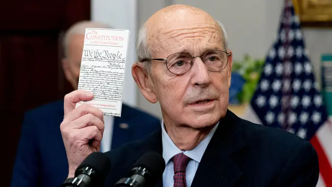 Mandatory Credit: Photo by Andrew Harnik/AP/Shutterstock (12778732aa)Supreme Court Associate Justice Stephen Breyer holds up a copy of the United States Constitution as he announces his retirement in the Roosevelt Room of the White House in WashingtonBiden, Washington, United States - 27 Jan 2022.