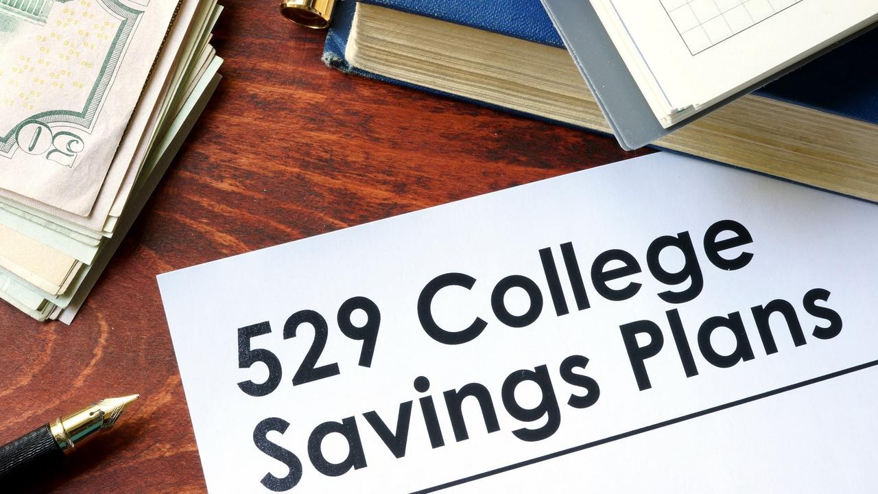 Papers with 529 College Savings Plans on a table. stock photo