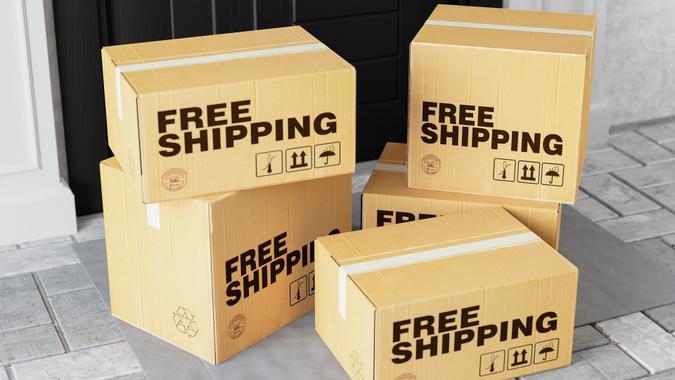 boxes at door read free shipping_iStock-1239928094 Internet Shopping,E-Commerce Delivery Service Concept with Cardboard Boxes stock photo