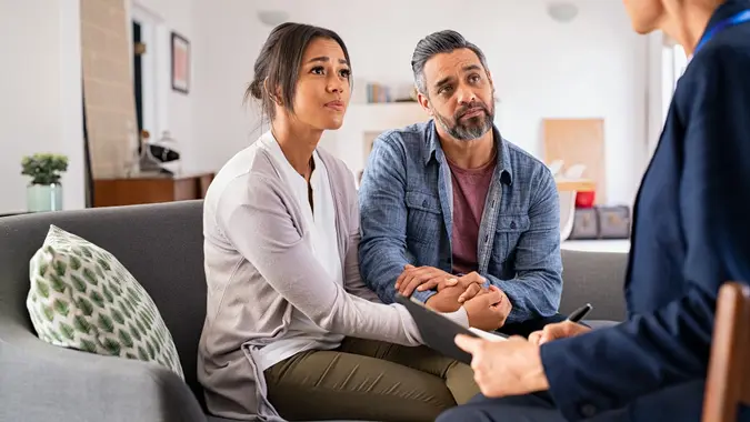 Worried couple meeting social counselor stock photo
