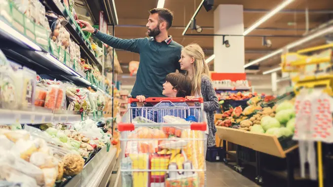 Father with son and daughter In A Supermarket. stock photo