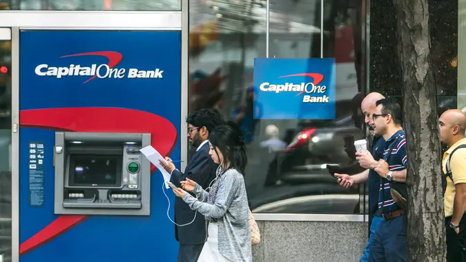 New York, July 19, 2016: A Capital One ATM on the streets of Manhattan with people walking by.