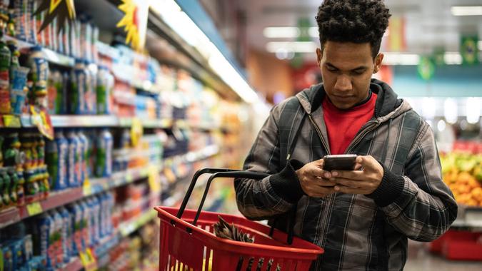 Customer Buying with mobile app on Supermarket stock photo