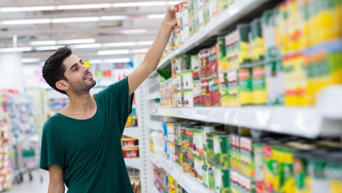 Taking canned food stock photo