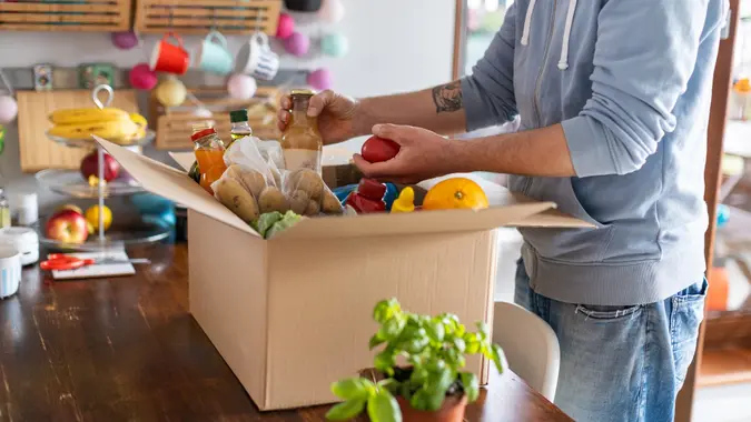 Man checking his fresh food delivery stock photo