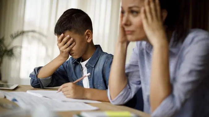 Teenage boy having problems in finishing homework stock photo
