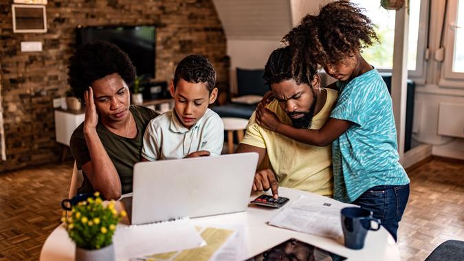 Frustrated African American family doing home finances. stock photo