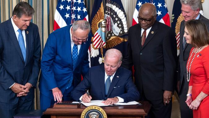 Mandatory Credit: Photo by JIM LO SCALZO/EPA-EFE/Shutterstock (13096600d)US President Joe Biden, surrounded by Democratic lawmakers, signs the Inflation Reduction Act in the State Dining Room of the White House in Washington, DC, USA, 16 August 2022.