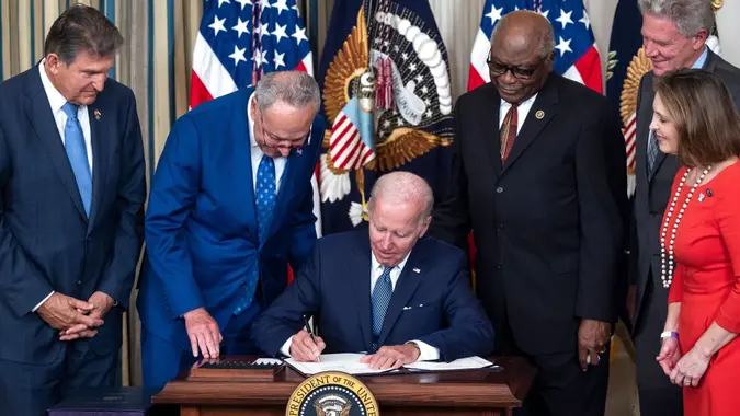 Mandatory Credit: Photo by JIM LO SCALZO/EPA-EFE/Shutterstock (13096600d)US President Joe Biden, surrounded by Democratic lawmakers, signs the Inflation Reduction Act in the State Dining Room of the White House in Washington, DC, USA, 16 August 2022.