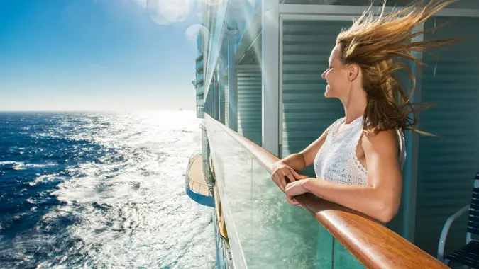 Happy woman looking at sea from a cruise ship. stock photo