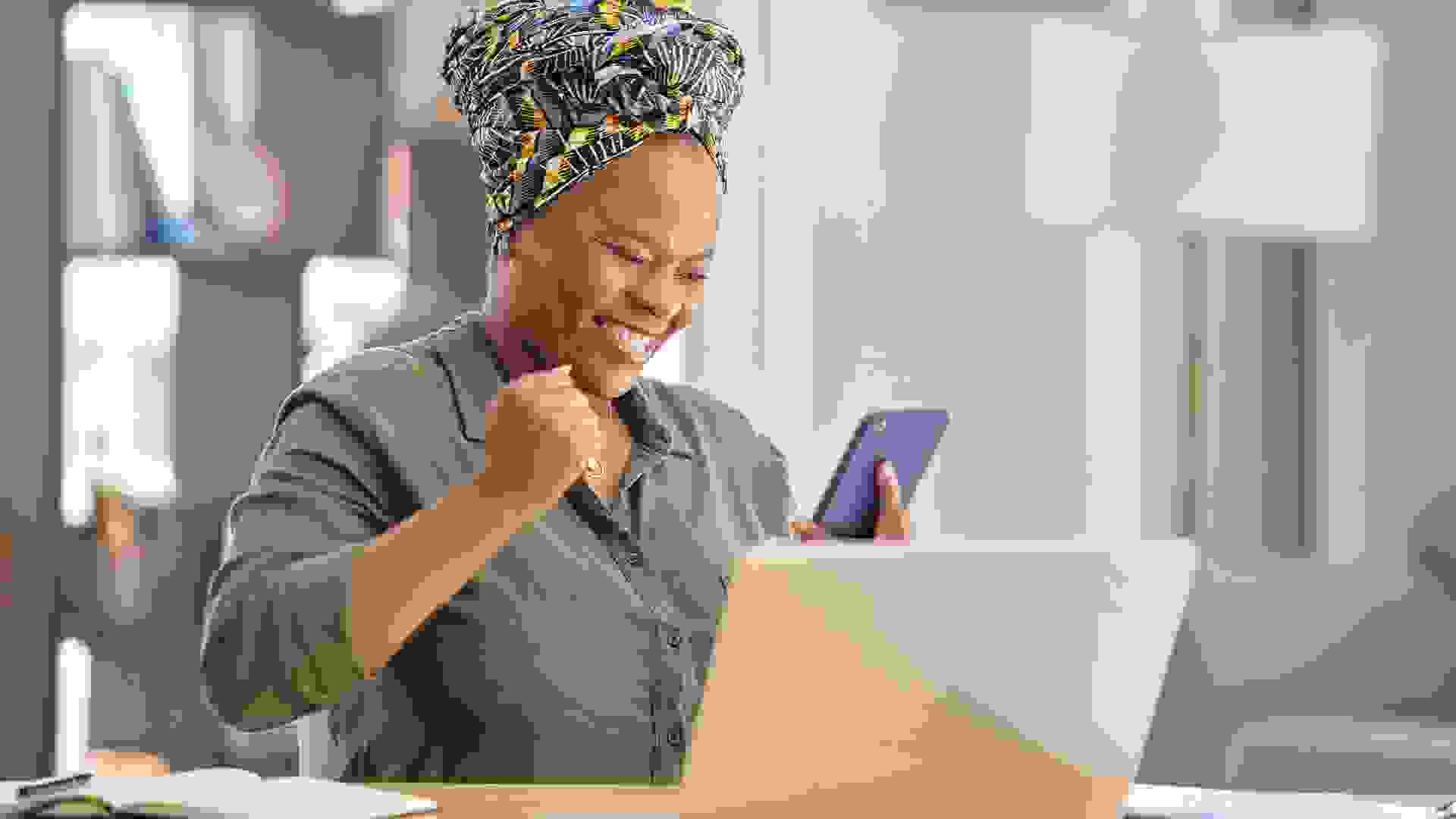 Shot of a businesswoman looking at her smartphone after receiving good news stock photo