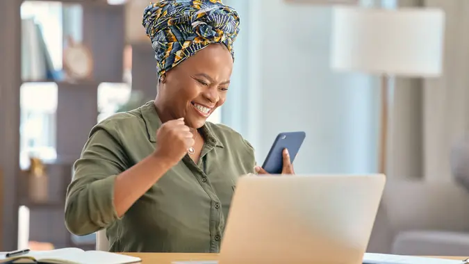 Shot of a businesswoman looking at her smartphone after receiving good news stock photo