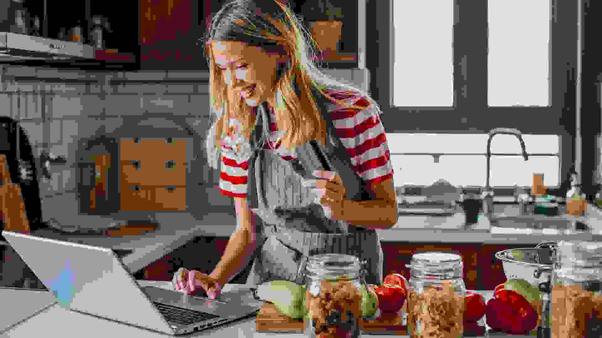 Young woman ordering food ingredients online stock photo