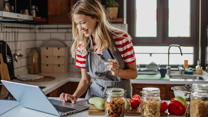 Young woman ordering food ingredients online stock photo