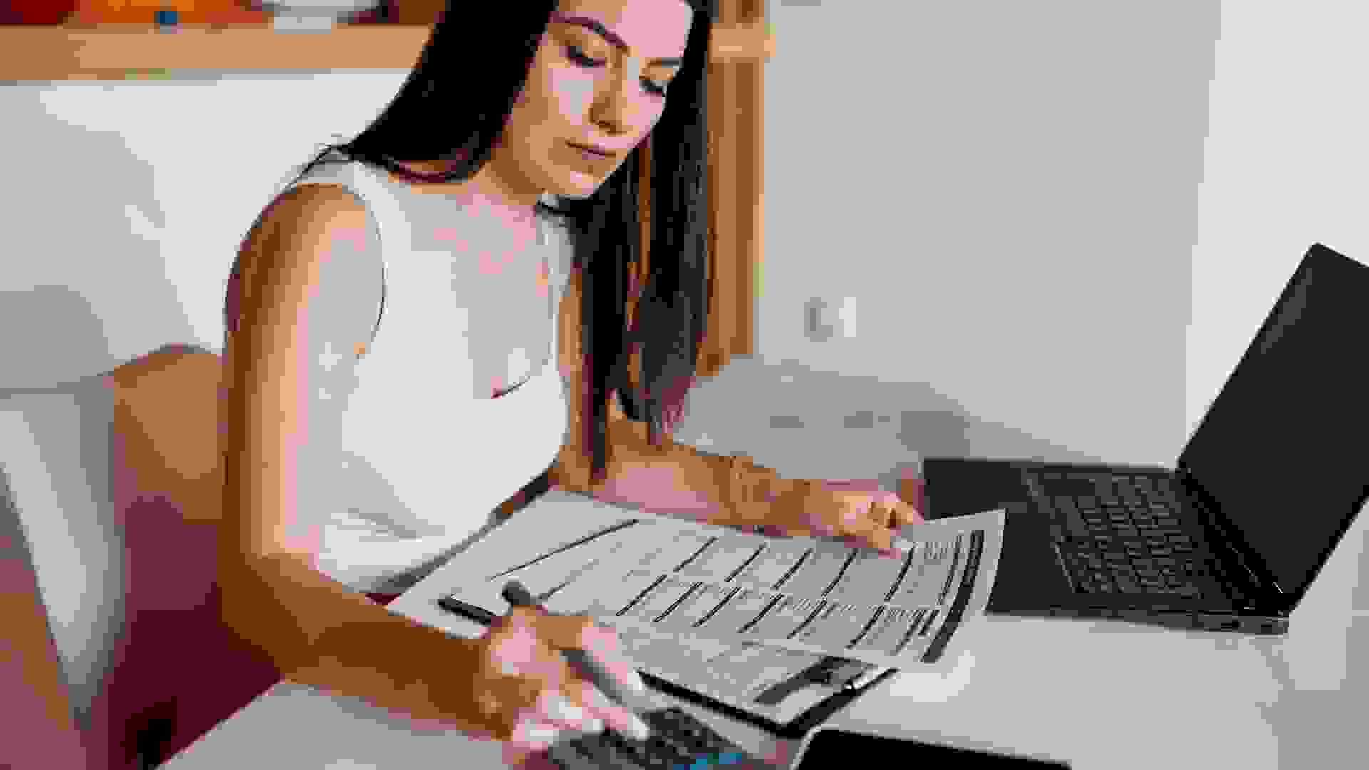 Woman paying bills from home stock photo