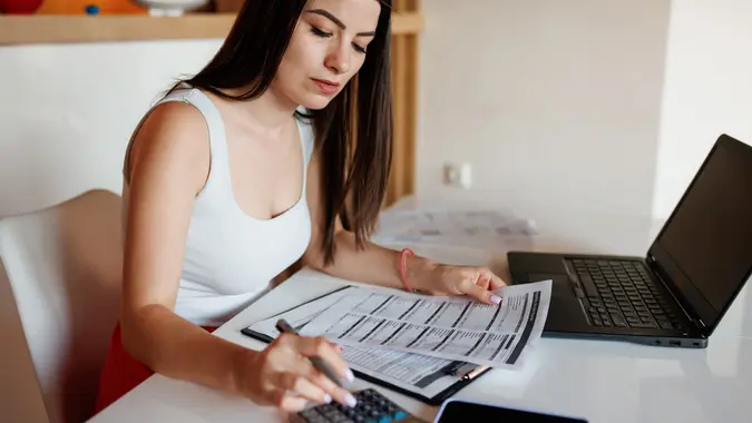 Woman paying bills from home stock photo