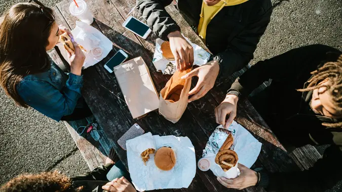 Group of Young Adults Eating Fast Food stock photo