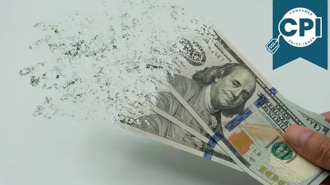 The man's hand holds a 10000 Korean won, which crushes and flutters in the wind.