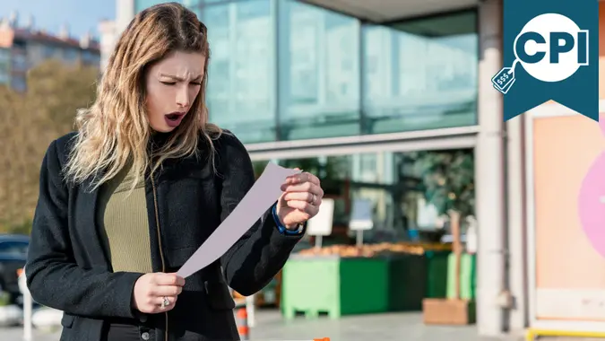 Woman Checking Shopping Bills at the Supermarket stock photo