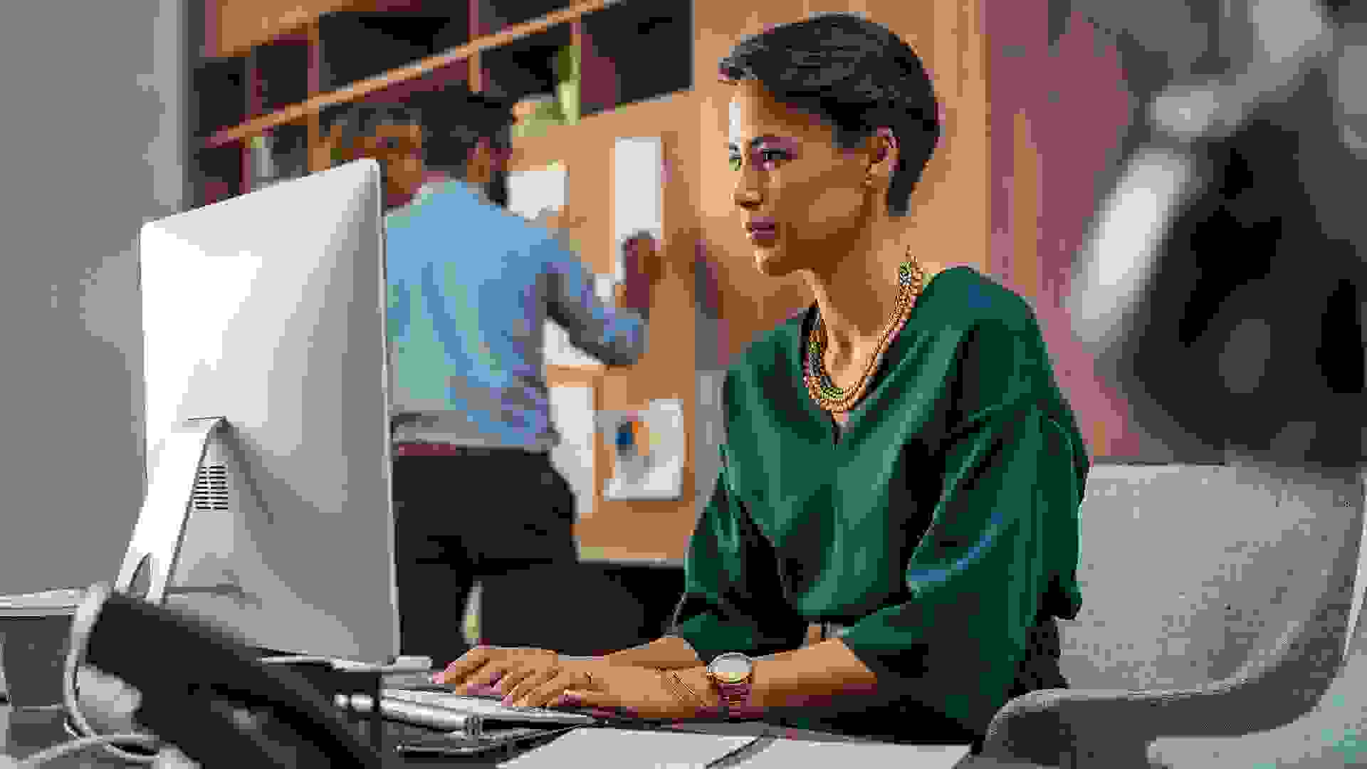 Young creative woman working on computer stock photo