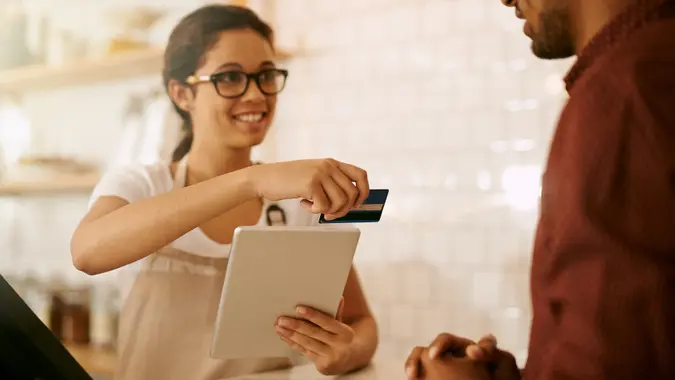 Cropped shot of a young woman accepting a card payment stock photo