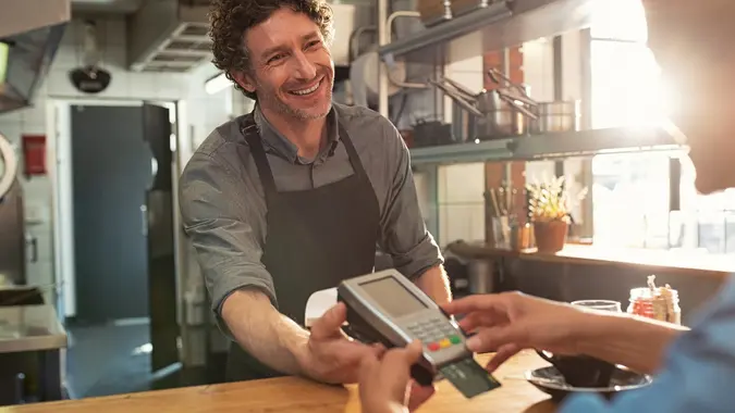 Waiter accepting payment by card stock photo