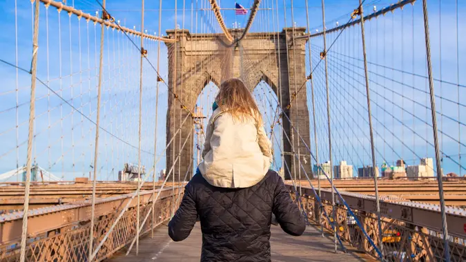 Dad and little girl on Brooklyn bridge, New York City stock photo