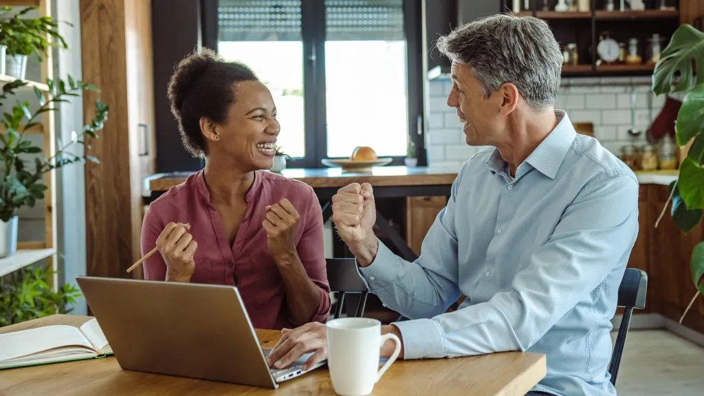 couple receiving great news on improving their credit score
