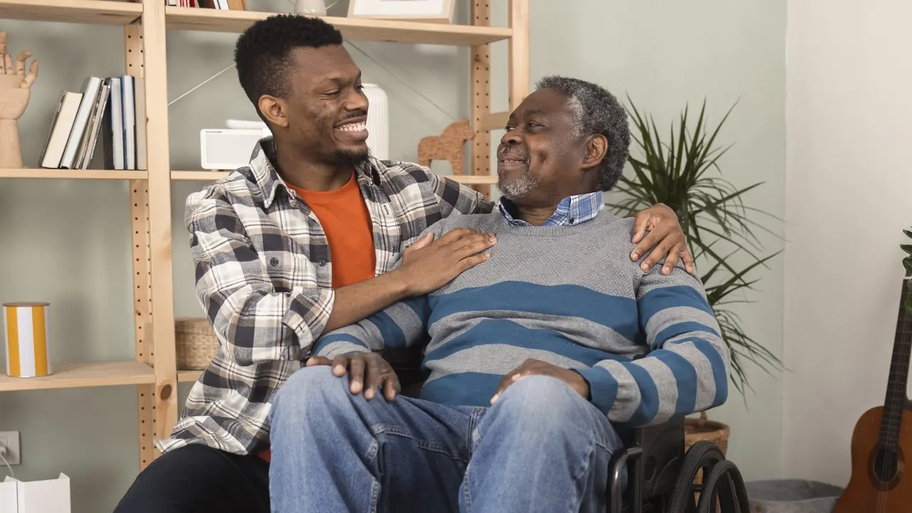 Young African American visiting his old dad to play one chess game stock photo