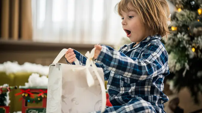 Cute little boy have surprise gift for Christmas.