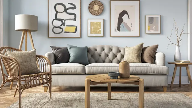 Bohemian living room interior 3d render with  beige colored furniture and wooden elements and light blue colored wall.