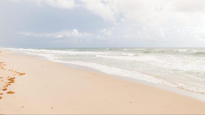 Ocean Waves Splashing Along the Empty Beach Shoreline in Manalapan, Florida in August of 2021 During the Rise of the COVID-19 Delta Variant.
