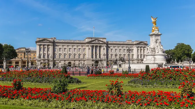London, UK - July 18, 2015: The outside of Buckingham Palace in London during the summer showing the Main Palace, Victoria Memorial and flowers.