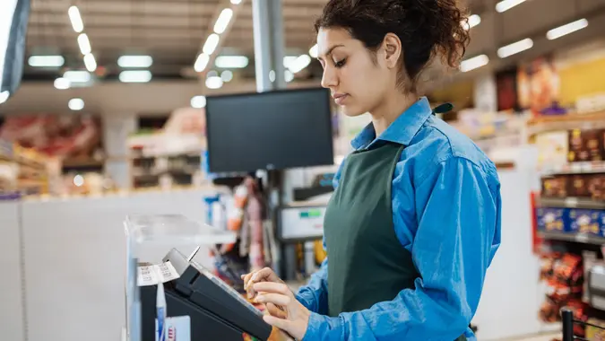 Female Latina employee in supermarket stock photo