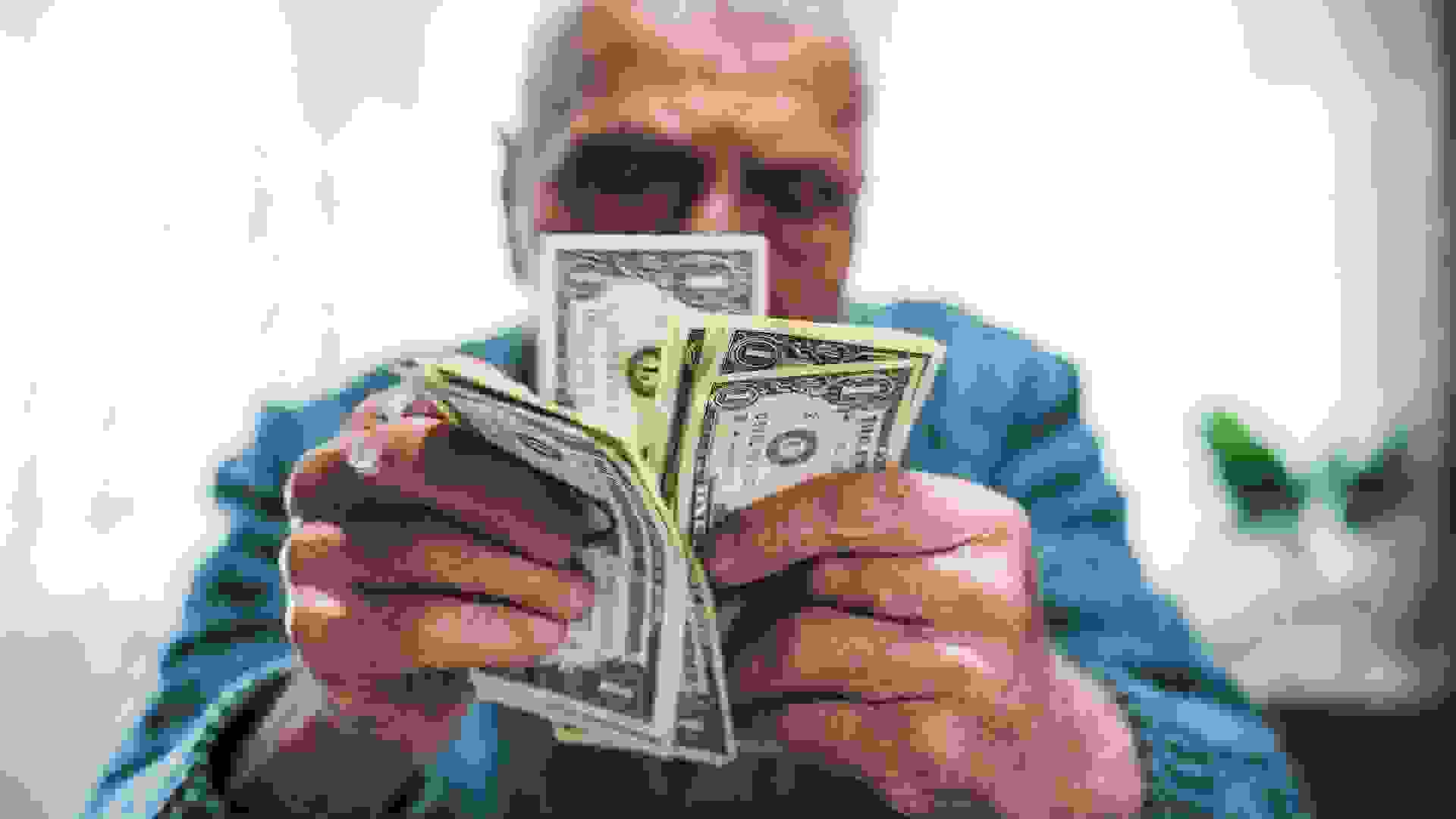 Senior man holding savings stock photo