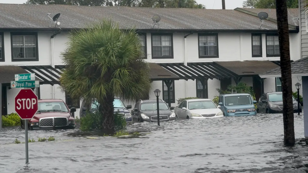 Mandatory Credit: Photo by John Raoux/AP/Shutterstock (13429238b)Vehicles sit in flood water at the Palm Isle apartments in the aftermath of Hurricane Ian, in Orlando, Fla.