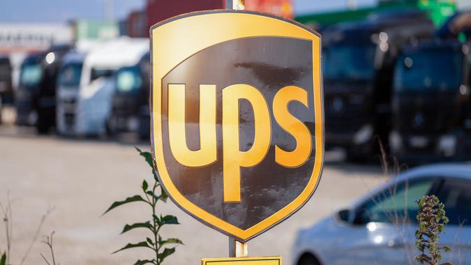 The sign of the American multinational parcel delivery company, United Parcel Service (UPS), stands near the container terminal in Nuremberg.  image bank