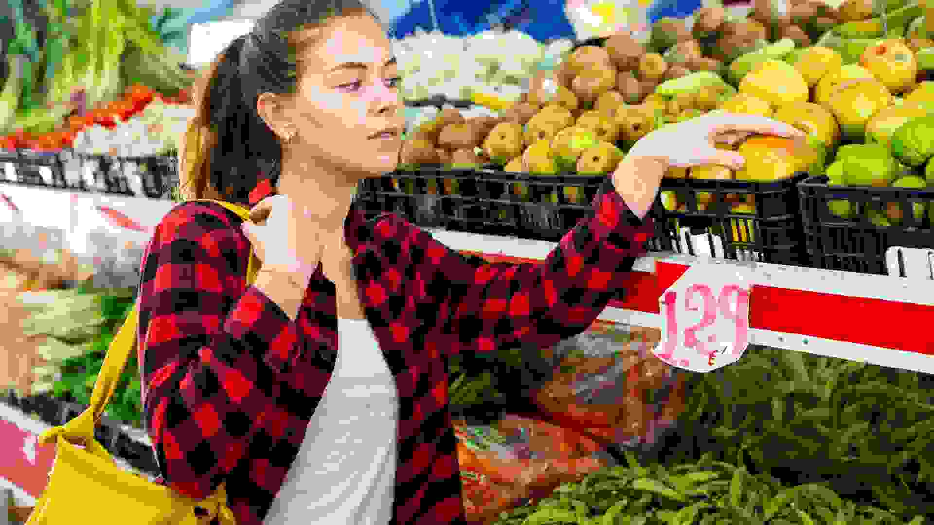 Portrait of nice young woman buying fresh apples stock photo
