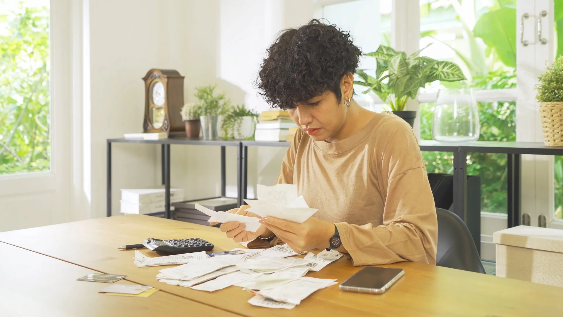 Portrait of stressed Asian woman, audit person and confused by calculate expense from invoice or receipt bills debt.