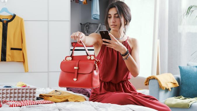 Woman selling her bag online stock photo